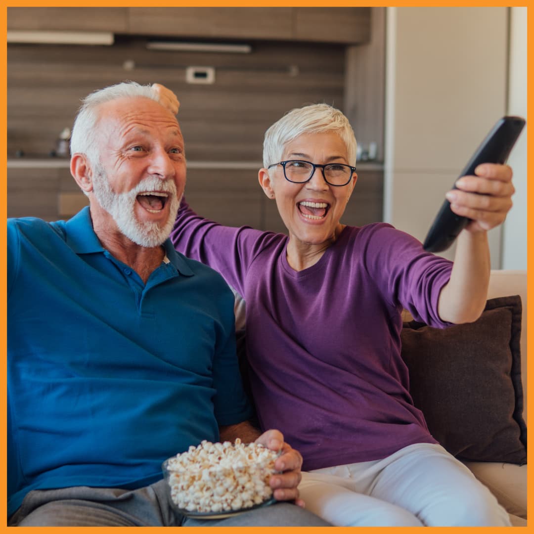 Senior couple enjoying community channel programming